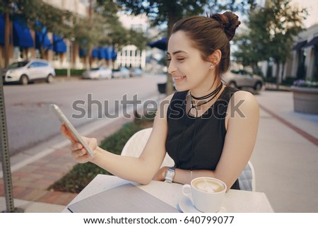 beautiful young girl is typing on phone