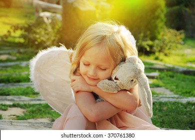 Beautiful young girl wearing angel wings 