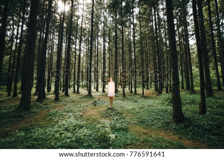 Similar – Image, Stock Photo Young woman with hat taking a walk in the deep forest at sunset.