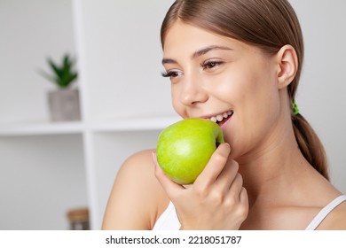 Beautiful Young Girl With White Teeth Holding Hands Of Fresh Green Apple.