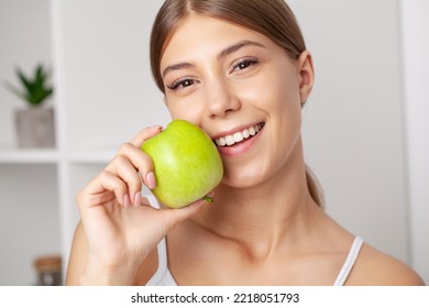 Beautiful Young Girl With White Teeth Holding Hands Of Fresh Green Apple.