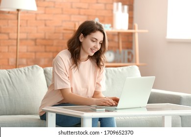Beautiful young girl working on laptop at home - Shutterstock ID 1709652370