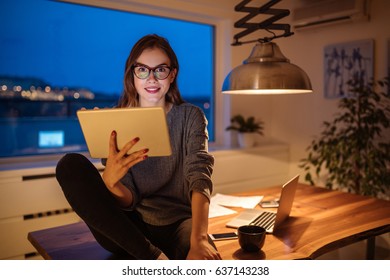 Beautiful Young Girl Working On A Tablet At Home.