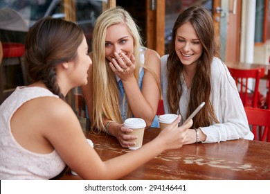 Beautiful Young Girls Having Coffee At Outdoor Cafe With Mobile Cell Phone