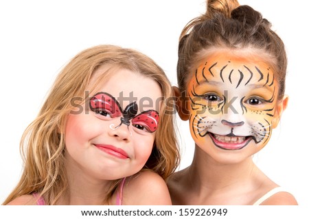 Beautiful young girls with painted faces, tiger and ladybug