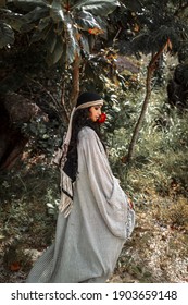 Beautiful Young Gypsy Style Woman With Red Rose Outdoors