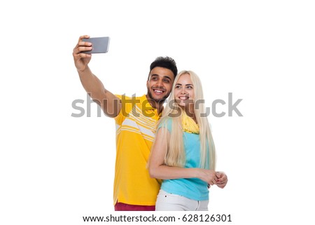 Beautiful Young Happy Couple Love Smiling Embracing Taking Selfie Photo On Cell Smart Phone, Hispanic Man Woman Isolated Over White Background