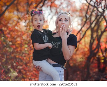 Beautiful Young Happy Mother With Little Girl. Closeup Of Happy Family On Walk In Foerest In Sunshine. Happy Family On Autumn Walk.