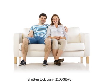 Beautiful Young Happy Smiling Pregnant Couple Sitting On Sofa, Isolated On White Background