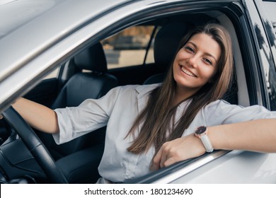 Beautiful young happy smiling woman driving her car. - Shutterstock ID 1801234690