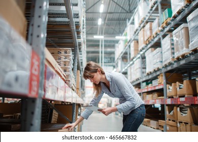 beautiful young hardware store worker stock taking