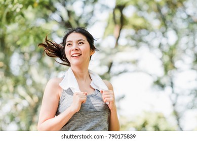 Beautiful Young Healthy Asian Woman Running In The Park In The Morning