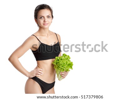 Beautiful young healthy woman with salad leaves. Diet and healthy eating