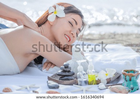 Beautiful, young and healthy woman in spa massage on beach near sea