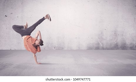 A Beautiful Young Hip Hop Dancer Dancing Contemporary Urban Street Dance In Empty Clear Grey Wall Background Concept.