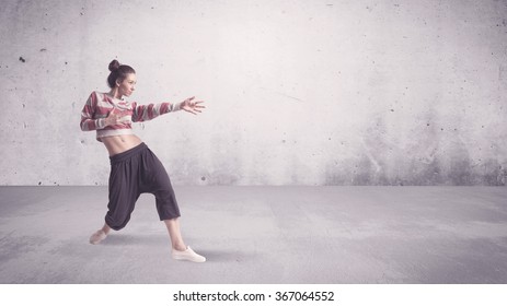 A Beautiful Young Hip Hop Dancer Dancing Contemporary Urban Street Dance In Empty Clear Grey Wall Background Concept.