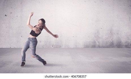 A Beautiful Young Hip Hop Dancer Dancing Contemporary Urban Street Dance In Empty Clear Grey Wall Background Concept.