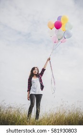 Beautiful young hipster woman holding with colorful of balloons outdoor, Freedom enjoy with nature. Women lifestyle concept.