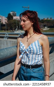 A Beautiful Young Hispanic Redhead Looking To Her Right. Medium Shot, Portrait Orientation.