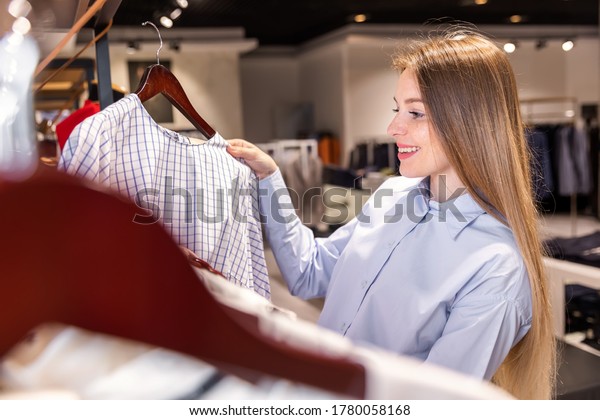 beautiful young holder of a fashion store checks\
a product in her\
boutique
