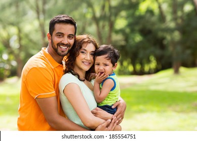 Beautiful Young Indian Family Outdoors Looking At The Camera