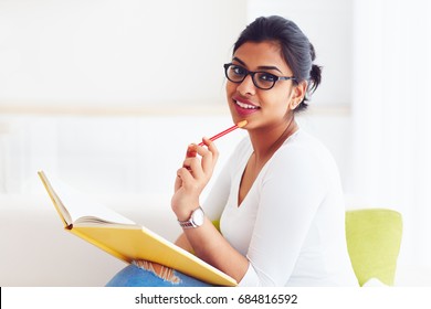 beautiful young indian girl, student with book, studying
