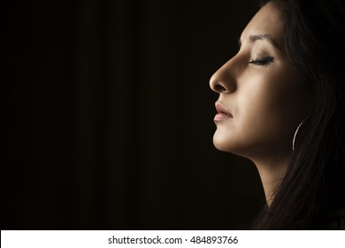 Beautiful Young Indian Woman Side Profile Portrait On Dark Background.