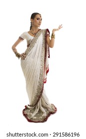 Beautiful Young Indian Woman in Traditional Clothing with Bridal Makeup and Oriental Jewelry. Beautiful Girl Bollywood dancer (Bellydancer) in Sari with open Hand palm. 