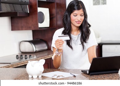 Beautiful Young Indian Woman Using Credit Card Shopping Online