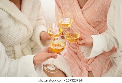 Beautiful young ladies toasting at pamper party indoors, closeup. Woman's Day