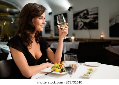 Beautiful young lady alone in restaurant 