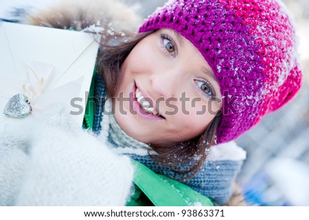 Beautiful young lady having fun outdoors in winter