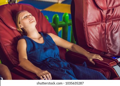 Beautiful young lady relaxing in the massage chair