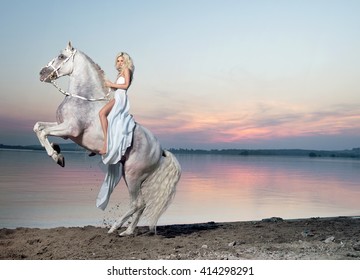 Beautiful Young Lady Riding A White Horse