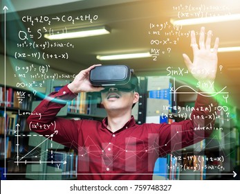 A Beautiful Young Man In A Library Travels In A Virtual Futuristic World With Augmented Reality. Concept: Educational, Future, Library, And Immersive Technology.