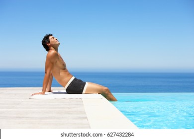 Beautiful Young Man Relaxing Near Pool