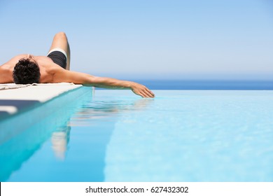 Beautiful Young Man Relaxing Near Pool