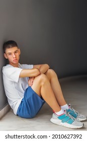 Beautiful Young Man Of Teenage Age Is Sitting On The Sidewalk Near Gray Concrete Wall, Lifestyle, Youth Trends, Lgbt Theme, Pride