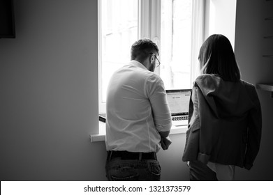 Beautiful young man and woman wearing casual working by laptop in the office - Shutterstock ID 1321373579