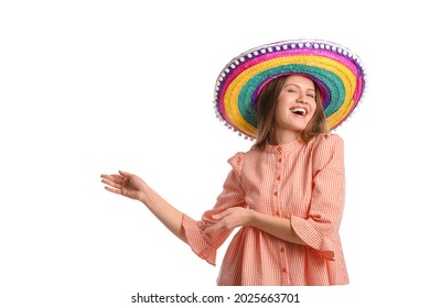 Beautiful young Mexican woman in sombrero hat showing something on white background