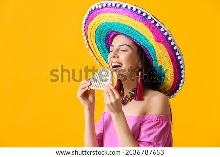 Beautiful young Mexican woman with tasty quesadilla on color background