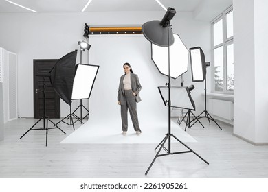 Beautiful young model posing in modern studio. Professional photo session - Powered by Shutterstock