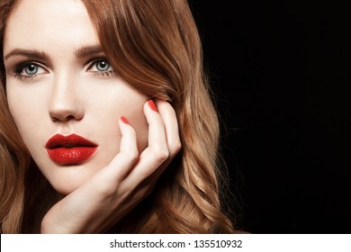 Beautiful Young Model With Red Lips And Red Manicure On Black Background