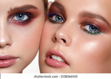 Beautiful Young Models With Professional Make Up, Perfect Skin. Trendy Colorful Eye-shadows. Blue Mascara, Eyeliner And Nude Lips.