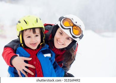 Beautiful Young Mom And Her Toddler Boy, Skiing In The Mountains, Winter Time