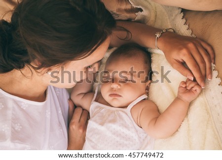 Similar – Mother hugging her newborn baby girl