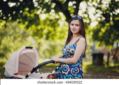 Beautiful Young Mother With Baby Trolley