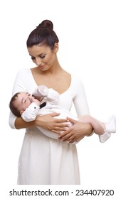 Beautiful Young Mother Holding Baby Boy In Arm. Baby Drinking From Feeding Bottle, Wearing Bow Tie And Shirt.