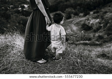 Image, Stock Photo scared boy hiding in his mom’s dress