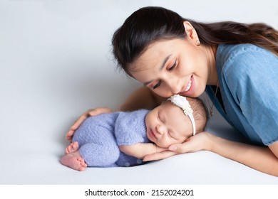 Beautiful young mother with a newborn daughter in a diaper on a white background. Motherhood. Tenderness. Space for text. High quality photo - Shutterstock ID 2152024201